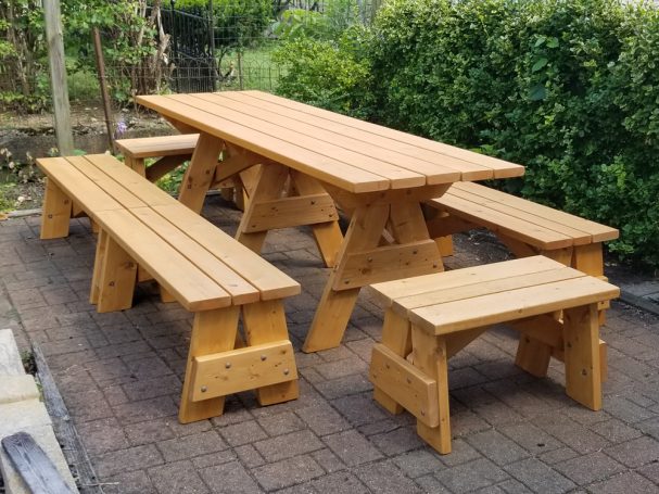 Commercial quality Custom Eco-friendly Outdoor Detached Bench Picnic Table with six benches slanted left on a patio.