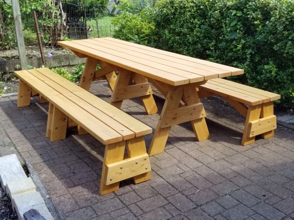 Commercial quality Custom Eco-friendly Outdoor Detached Bench Picnic Table with four benches slanted left on a patio.