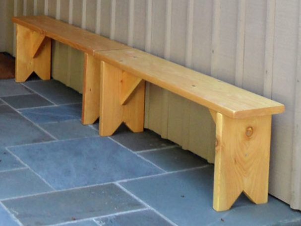 Two Commercial quality eco-friendly Outdoor Farmhouse Bench slightly slanted to the left on a patio.