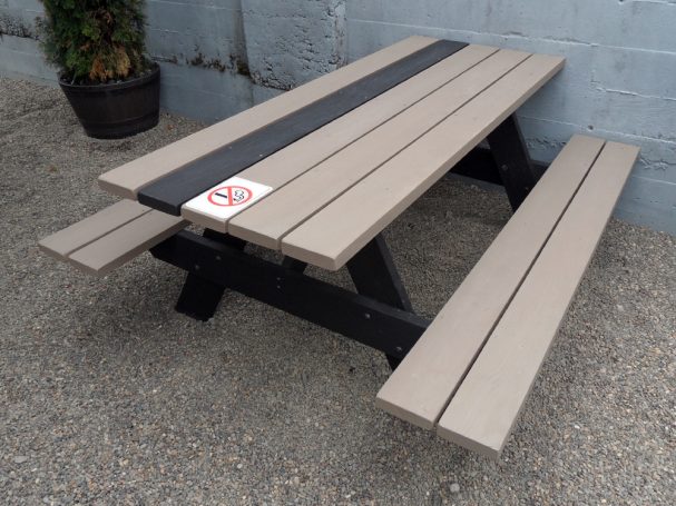 Black and gray Commercial quality eco Outdoor Attached Bench Picnic Table slanted right on a restaurant bar patio.