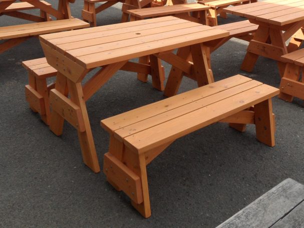 Commercial quality Custom Eco Outdoor Detached Bench Picnic Table with two benches slanted right at a restaurant bar.