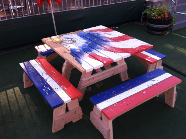Painted Commercial quality Eco Outdoor Square Detached Bench Picnic Table with four benches slanted left at an event.