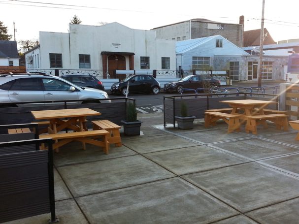 Two Commercial quality Eco Outdoor Square Detached Bench Picnic Tables with four benches on a restaurant bar patio.
