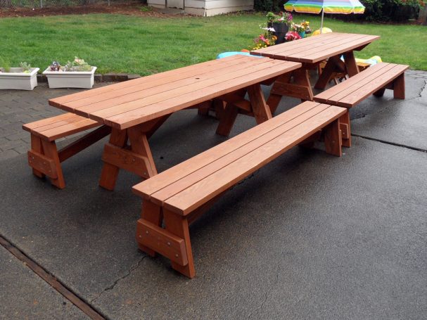 Two Large Commercial quality Custom Eco Outdoor Detached Bench Picnic Tables with two benches slanted right on a patio.