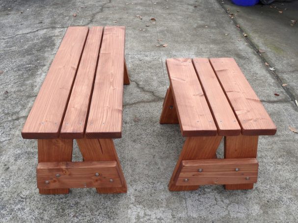 Side view of a short and a medium Commercial quality eco-friendly Outdoor Picnic Table Bench on the sidewalk.