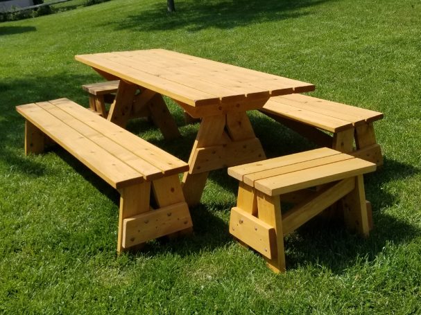 Commercial quality Custom Eco-friendly Outdoor Detached Bench Picnic Table with six benches slanted left in a backyard.