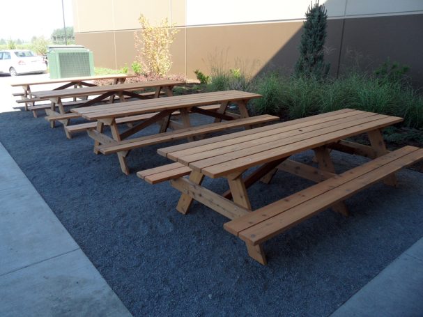 Large Commercial quality eco-friendly Outdoor Attached Bench Picnic Tables in a row at an office building.