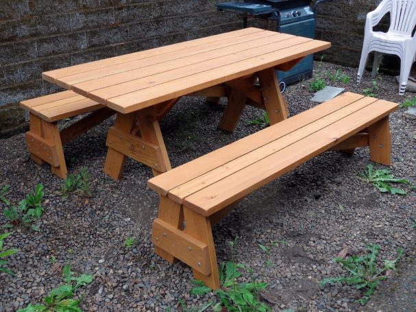 Commercial quality Custom Eco-friendly Outdoor Detached Bench Picnic Table with two benches slanted right in a backyard.