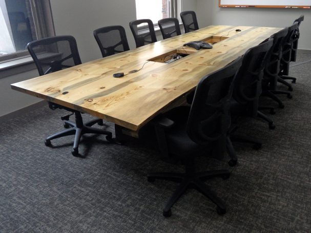 Custom Live Edge Blue Pine Slab Conference Table with reclaimed antique machinery bases slanted to the left.