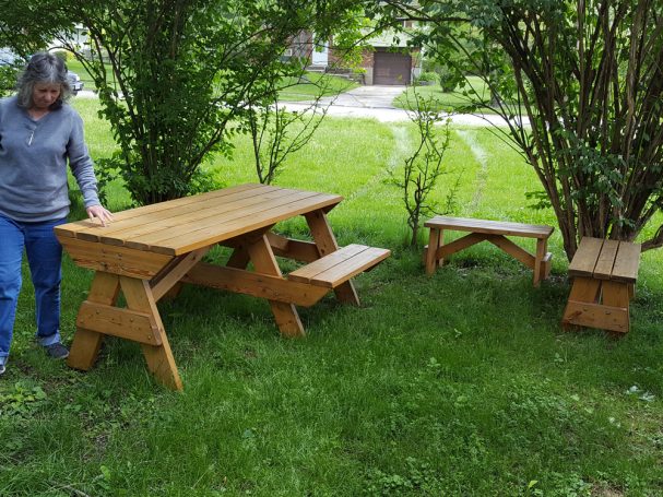 7' Commercial quality Custom Eco Outdoor Hybrid Bench Picnic Table with two benches slanted right in a backyard.