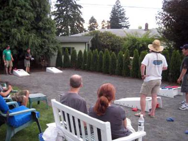 People playing in a cornhole tournament on sturdy high quality solid box design Cornhole Board Sets in a backyard.