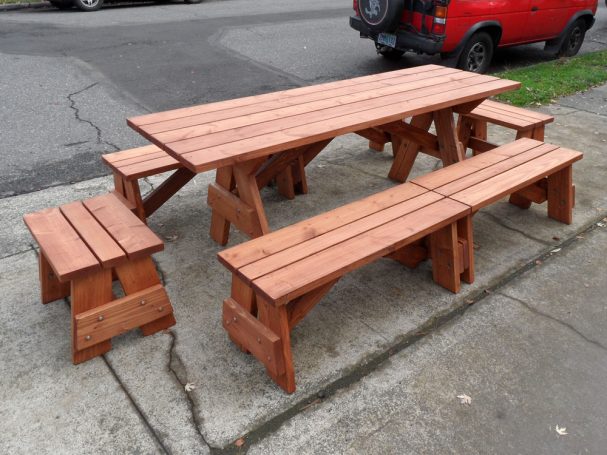 Commercial quality Custom Eco-friendly Outdoor Detached Bench Picnic Table with six benches slanted right on a sidewalk.