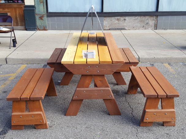 7' Commercial quality Custom Eco-friendly Outdoor Hybrid Bench Picnic Table with two benches from the front at an event.