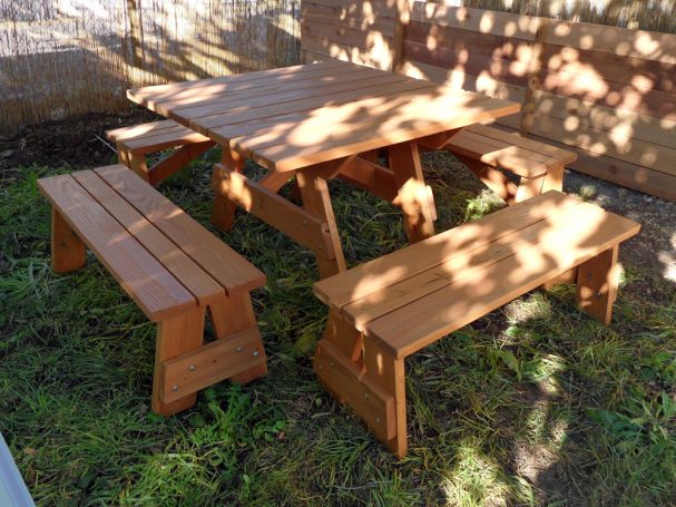Commercial quality Eco-friendly Outdoor Square Detached Bench Picnic Table with four benches slanted right in a corner.