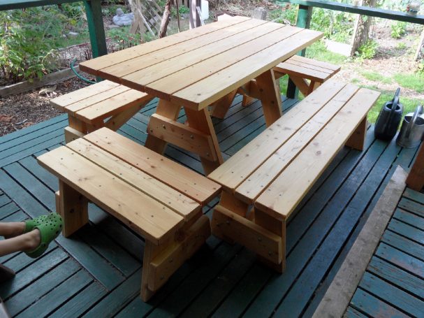 Commercial quality Custom Eco-friendly Outdoor Detached Bench Picnic Table with six benches slanted right on a deck.
