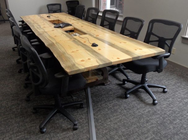 Custom Live Edge Blue Pine Slab Conference Table with reclaimed antique machinery bases slanted to the right.