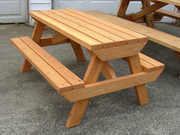 4' Commercial quality Eco-friendly Outdoor Kids Attached Bench Picnic Table slanted to the left on a sidewalk.