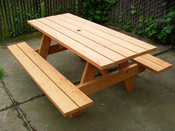 Commercial quality eco-friendly Outdoor Attached Bench Picnic Table slanted to the left on a patio.