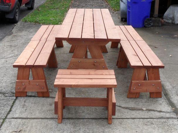Commercial quality Custom Eco-friendly Outdoor Detached Bench Picnic Table with six benches from the front on sidewalk.