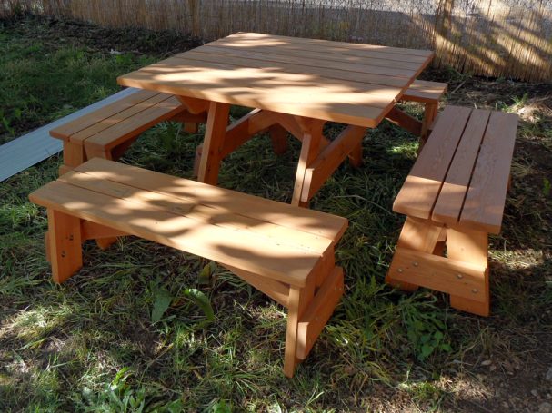 Commercial quality Eco-friendly Outdoor Square Detached Bench Picnic Table with four benches slanted left in backyard.