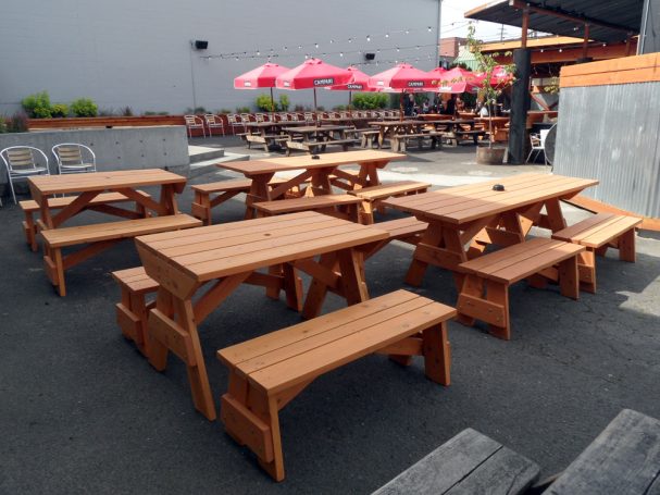 4' Commercial quality Custom Eco Outdoor Detached Bench Picnic Tables with two benches on a restaurant bar patio.