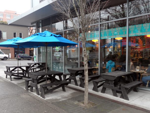 Commercial quality Custom Eco-friendly Outdoor Hybrid Bench Picnic Tables in front of a restaurant bar.