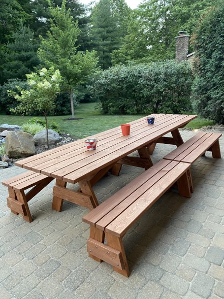 Large Commercial quality Custom Eco Outdoor Detached Bench Picnic Table with four benches slanted right on a patio.