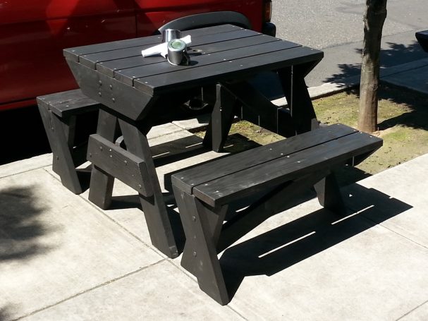 Front of a 4' Commercial quality Custom Eco-friendly Outdoor Hybrid Bench Picnic Table on a restaurant bar patio.