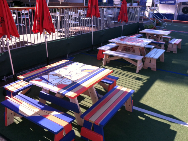 Hand painted Commercial quality Eco Outdoor Square Detached Bench Picnic Tables in a row to the right at an event.