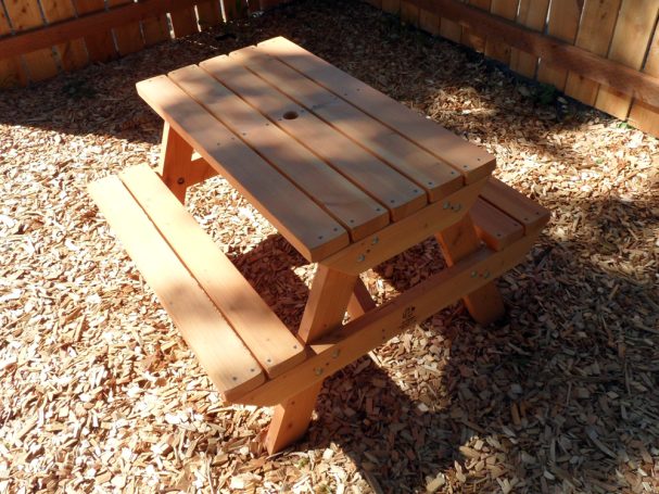 Commercial quality Eco-friendly Outdoor Kids Attached Bench Picnic Table slanted to the left in a backyard.