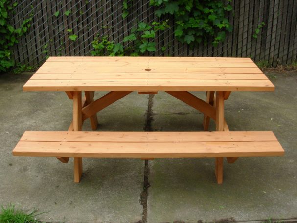 Commercial quality eco-friendly Outdoor Attached Bench Picnic Table from the side on a patio.
