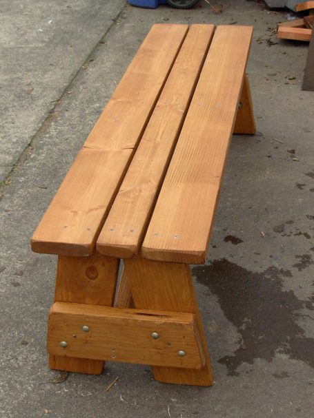 A large Commercial quality eco-friendly Outdoor Picnic Table Bench slanted to the right.