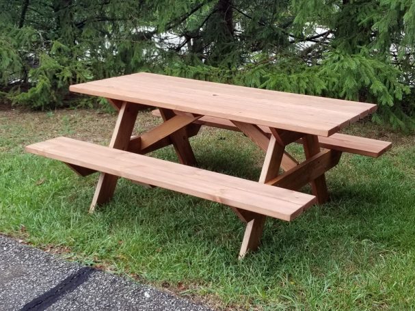 Commercial quality eco-friendly Outdoor Attached Bench Picnic Table slanted to the left in a backyard.