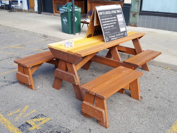 7' Commercial quality Custom Eco-friendly Outdoor Hybrid Bench Picnic Table with two benches slanted right at an event.