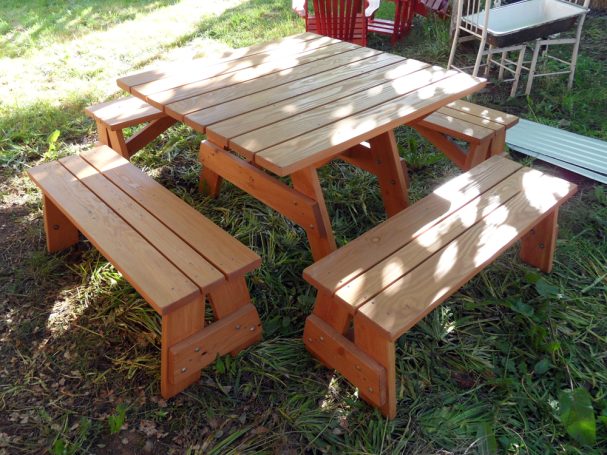 Commercial quality Eco-friendly Outdoor Square Detached Bench Picnic Table with four benches slanted right in backyard.