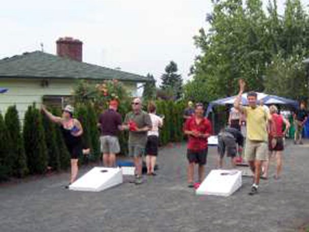 People playing in a cornhole tournament on back-to-back sturdy high quality solid box design Cornhole Board Sets.