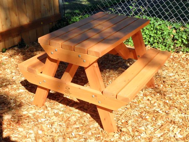 Commercial quality Eco-friendly Outdoor Kids Attached Bench Picnic Table slanted to the right in a backyard.