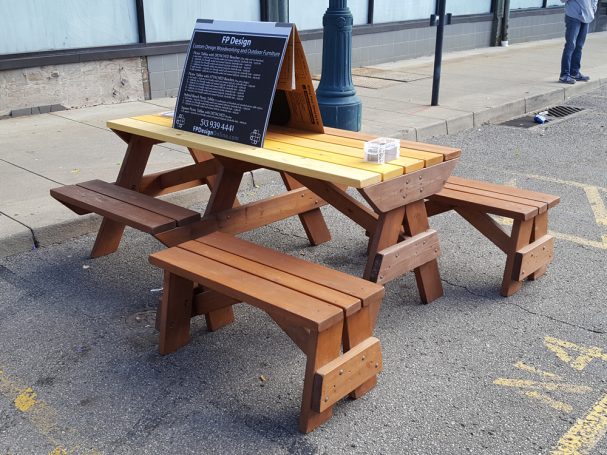 7' Commercial quality Custom Eco-friendly Outdoor Hybrid Bench Picnic Table with two benches slanted left at an event.
