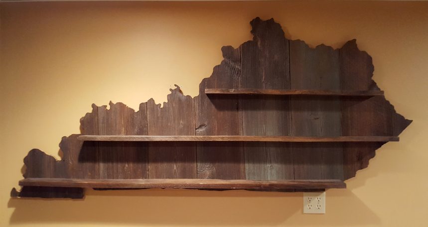 Handcrafted Barnwood Kentucky Derby Glass Shelf without glasses hanging flat on a yellow wall. 