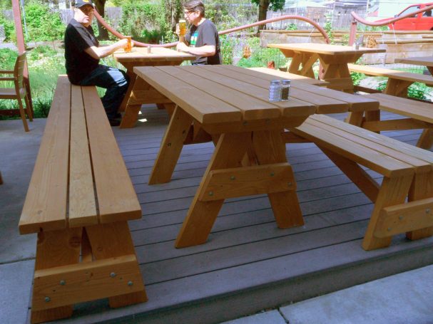 Commercial quality Custom Eco-friendly Outdoor Detached Bench Picnic Table with two benches on a restaurant bar patio.