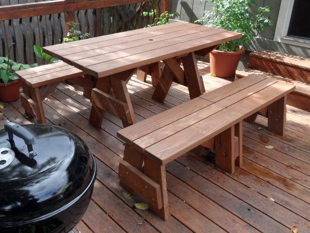 Commercial quality Custom Eco-friendly Outdoor Detached Bench Picnic Table with four benches slanted right on a deck.
