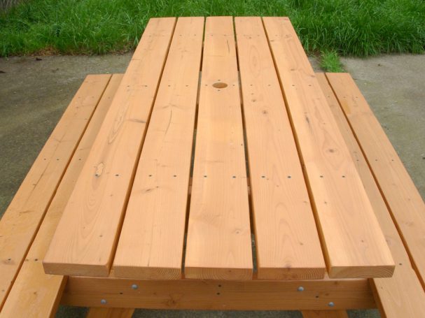 Commercial quality eco-friendly Outdoor Attached Bench Picnic Table from the front on a patio.