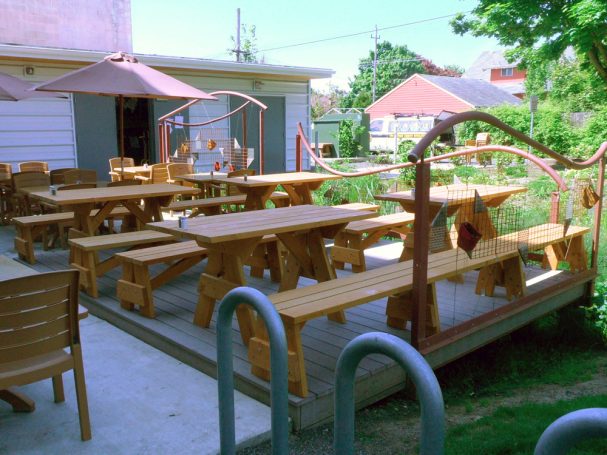 Commercial quality Custom Eco-friendly Outdoor Detached Bench Picnic Tables with two benches on a restaurant bar patio.