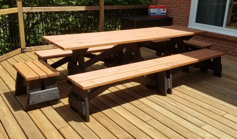 Large tow-tone Commercial quality Custom Eco Outdoor Detached Bench Picnic Table with six benches slanted right on deck.