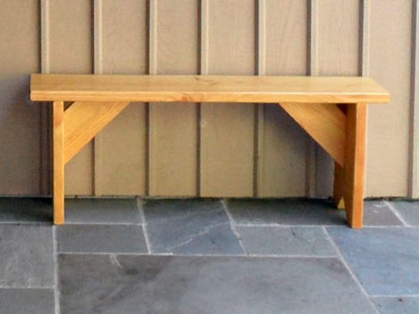 Front of a Commercial quality eco-friendly Outdoor Farmhouse Bench on a patio.