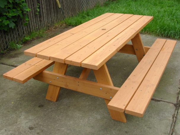 Commercial quality eco-friendly Outdoor Attached Bench Picnic Table slanted to the right on a patio.