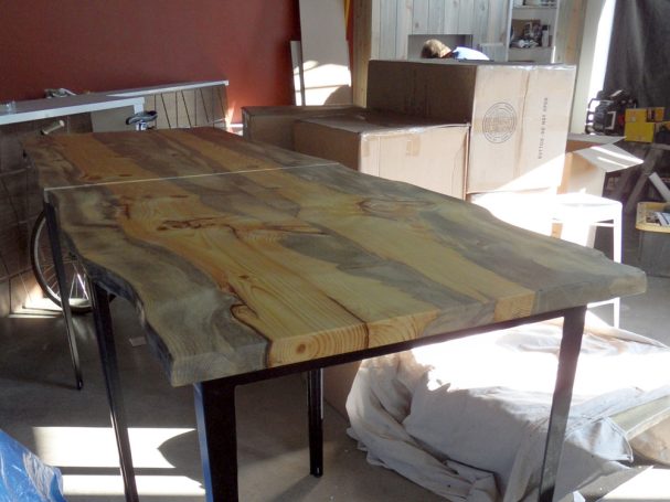Two-part commercial quality Blue Pine Live Edge Slab Table Top dining table slanted to the left at a restaurant bar.