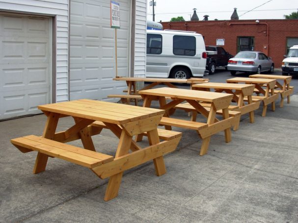 4' Commercial quality eco-friendly Outdoor Attached Bench Picnic Tables in a row slanted to the right on a sidewalk.