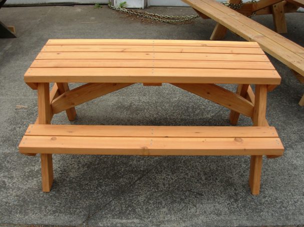 4' Commercial quality Eco-friendly Outdoor Kids Attached Bench Picnic Table from the side on a sidewalk.