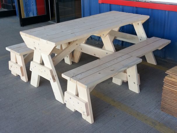 7' Commercial quality Custom Eco Outdoor Hybrid Bench Picnic Table with two benches slanted right at a restaurant bar.